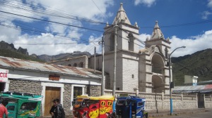 Church in Chivay with 'tuk tuk taxis'